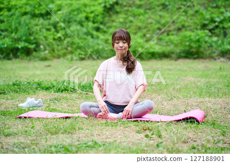 Yoga exercise stretching outdoor park middle-aged senior 127188901
