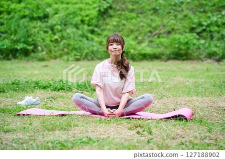 Yoga exercise stretching outdoor park middle-aged senior 127188902