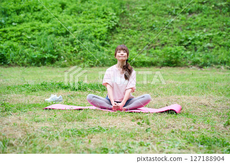 Yoga exercise stretching outdoor park middle-aged senior Yoga exercise stretching outdoor park middle-aged senior 127188904