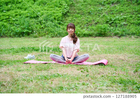 Yoga exercise stretching outdoor park middle-aged senior 127188905