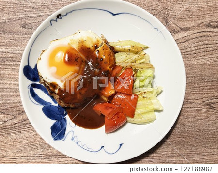 Delicious fried egg on hamburger steak and vegetables 127188982