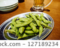 Chilled edamame and beer in an izakaya, close-up 127189234