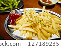 Delicious french fries in a pub, close-up 127189235