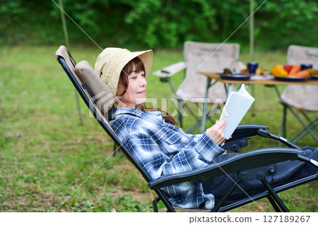 Woman reading a book, camping, leisure, middle-aged, senior Woman reading a book, camping, leisure, middle-aged, senior 127189267