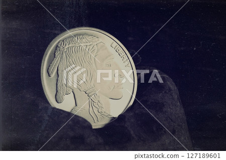United States Pure Silver coin with North American Indian head. Antique style photography. United States Pure Silver coin with North American Indian head. Antique style photography. 127189601
