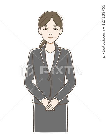 A woman in a suit standing facing forward and smiling A woman in a suit standing facing forward and smiling 127189755