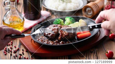 Hot hamburger steak cooked on a hot iron plate 127189999