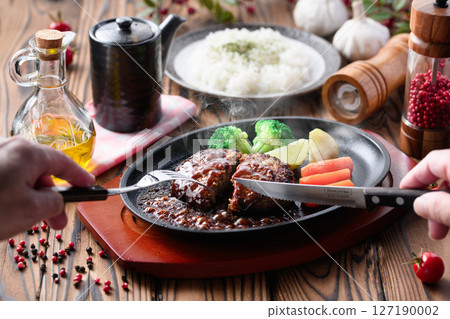 Hot hamburger steak cooked on a hot iron plate Hot hamburger steak cooked on a hot iron plate 127190002