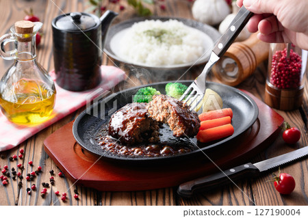 Hot hamburger steak cooked on a hot iron plate Hot hamburger steak cooked on a hot iron plate 127190004
