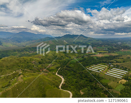 Green mountain valley and rainforest. Blue sky and clouds. Mindanao, Philippines. Green mountain valley and rainforest. Blue sky and clouds. Mindanao, Philippines. 127190061