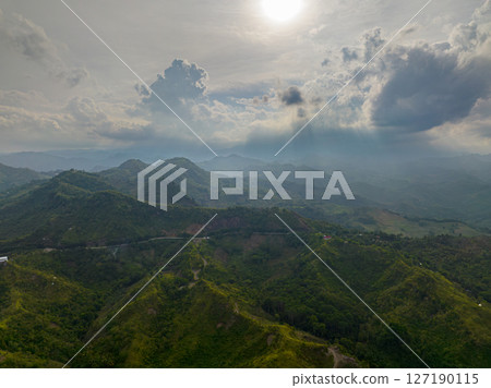 Drone view of cloudy mountain with lush foliage and green mountain hills. Mindanao, Philippines. 127190115