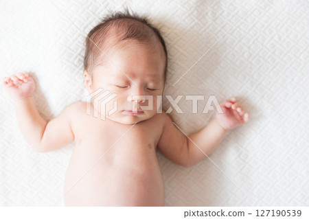 Sleeping face of a one-month-old baby 127190539