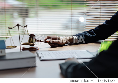 Close up lawyer hands holding pen, signing in white paper form or application to confirm and deal contract agreement 127191822