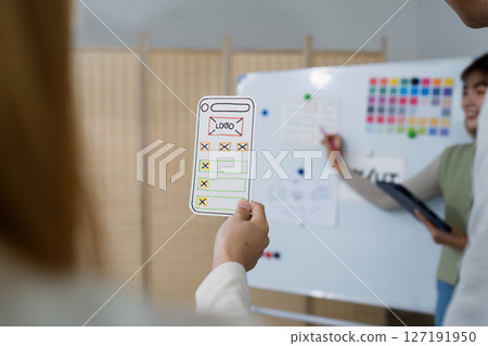 UI designer and UX developer brainstorm idea to design the application appearance in the early stage. Creative digital development agency. UX UI concept UI designer and UX developer brainstorm idea to design the application appearance in the early stage. Creative digital development agency. UX UI concept 127191950