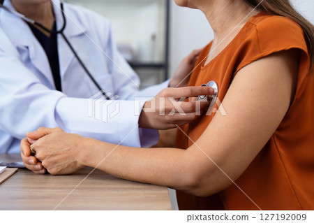 Doctor listens to heartbeat of older of retirement age to check their heart rate Doctor listens to heartbeat of older of retirement age to check their heart rate 127192009