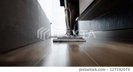 African American man cleaning the floor, butler mopping the floor with a mop in the living room 127192078