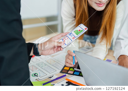 UI designer and UX developer brainstorm idea to design the application interface. Creative digital development agency. UX UI concept 127192124