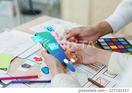 ux developer and UI designer team brainstorm together about designing application interface layout. Creative digital development agency. UX UI concept 127192157