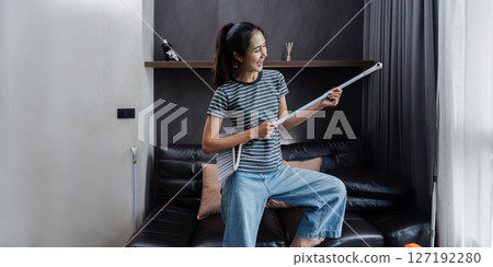 young asian woman having fun during cleaning, fooling with mop and broom young asian woman having fun during cleaning, fooling with mop and broom 127192280