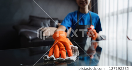 Housekeeping woman wiping the table in the living room. House cleaning service concept 127192285