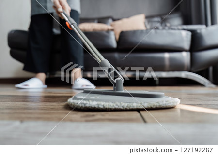 cleaning service housekeeper women swipe floor in living room. House cleaning service concept cleaning service housekeeper women swipe floor in living room. House cleaning service concept 127192287