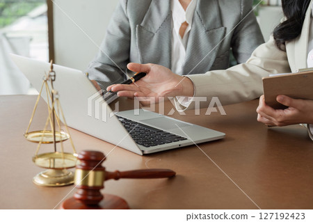 Lawyer and client discuss data on laptop, advise client on business matters on laptop Lawyer and client discuss data on laptop, advise client on business matters on laptop 127192423