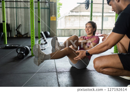 Fitness Coaching. Young woman receiving guidance during workout in gym. 127192614