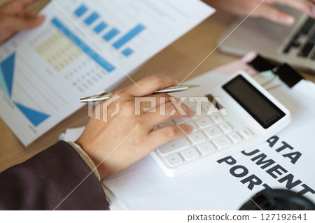 Financial Analysis and Planning. Professional reviewing data with calculator and reports. Financial Analysis and Planning. Professional reviewing data with calculator and reports. 127192641