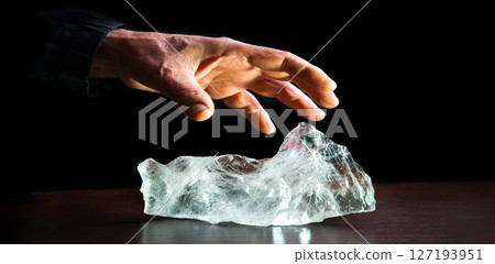 The hand reaches out to steal the precious stone 127193951