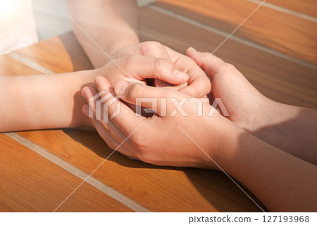 Close-up view of comforting hands 127193968