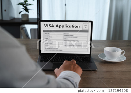 Visa application person filling out visa application 127194308