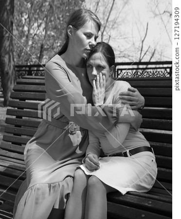 Two girls comfort one another Two girls comfort one another 127194309
