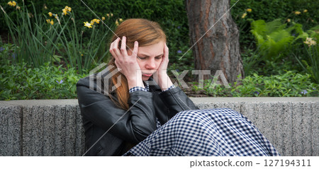 Sad girl in the park 127194311
