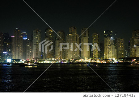 Dubai, UAE - September 28, 2024, Dubai nightlife, bright street lights, people and shops. Editorial 127194432