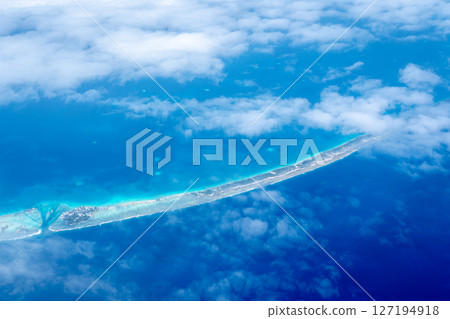 Aerial view of the Tuamotus atoll in French Polynesia with clouds 127194918