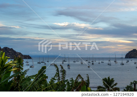 Taiohae Bay at sunset with sailboats in Nuku Hiva, Marquesas Islands, French Polynesia Taiohae Bay at sunset with sailboats in Nuku Hiva, Marquesas Islands, French Polynesia 127194920
