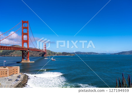 Golden Gate Bridge over blue waters with scenic hills in San Francisco Golden Gate Bridge over blue waters with scenic hills in San Francisco 127194939