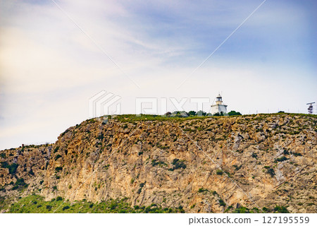 Lighthouse on cliff 127195559