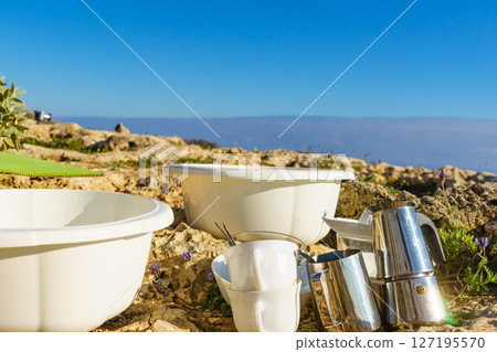 Washing dishes outdoors, capming 127195570