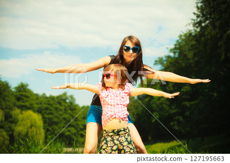 Summer. Girl kid child playing with mother outdoor 127195663