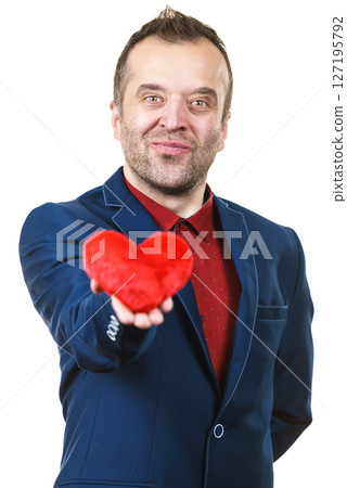 Man in suit holding heart Man in suit holding heart 127195792