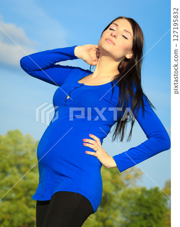 pregnant woman relaxing and enjoying life in nature 127195832