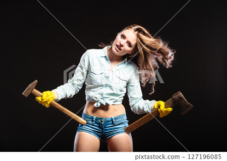 Sexy strong woman feminist with axes working. 127196085