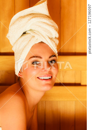 woman lying relaxed in wooden sauna woman lying relaxed in wooden sauna 127196097