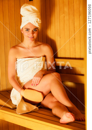 woman relaxing in wooden sauna room woman relaxing in wooden sauna room 127196098