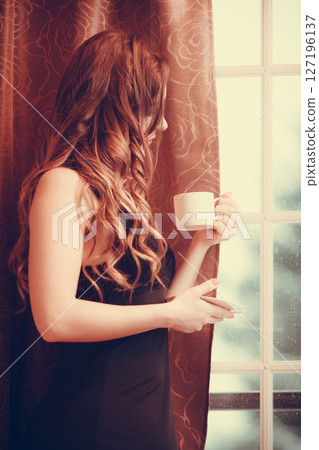 Sensual woman drinking hot coffee beverage at home 127196137