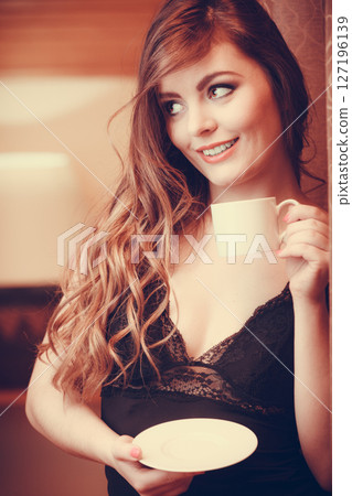 Sensual woman drinking hot coffee beverage at home 127196139