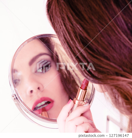 Beautiful woman with lipstick and mirror. Beautiful woman with lipstick and mirror. 127196147