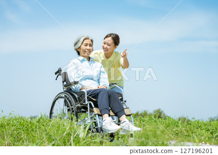 Wheelchair senior and caregiver 127196201