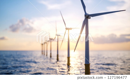 Renewable wind energy turbines at sunset in the mountains with a blue sky 127196477